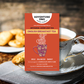English Breakfast Tea | Artisanal Loose Leaf label on background of cup of hot tea and biscuits. Flavor notes are bold, balanced, and smoky. Ingredients: African & Indian Black Tea