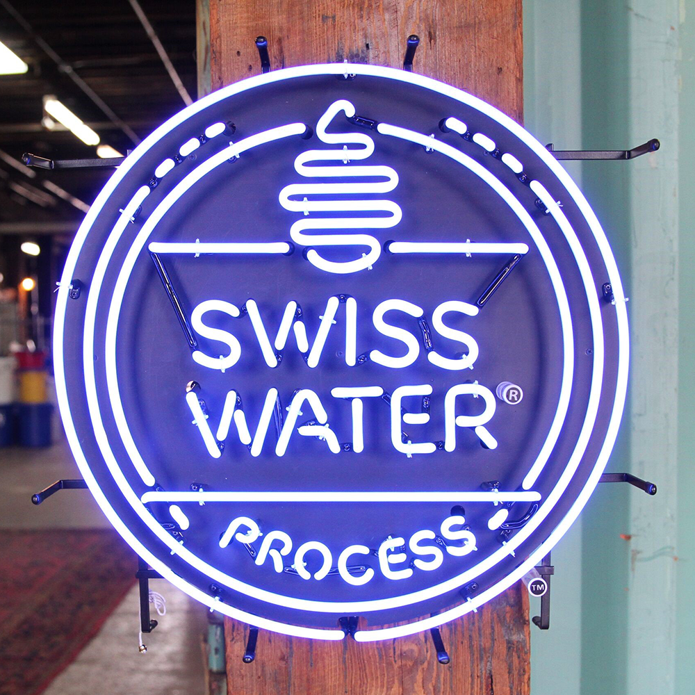 Adventure Dog Coffee's proud partnership with the Swiss Water Process. This Swiss Water Process neon sign is a symbol of our commitment to using the Swiss Water Process for decaffeinating our coffee beans ensures a chemical-free and environmentally friendly approach to producing decaf coffee. 